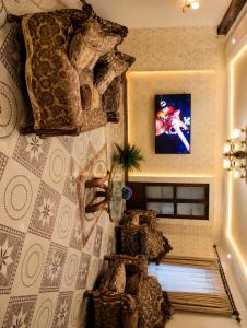 a living room with a tv on a wall at Zanzibar stone town house in Zanzibar City
