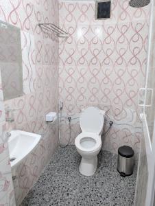 a bathroom with a toilet and a sink at Zanzibar stone town house in Zanzibar City +20 photos