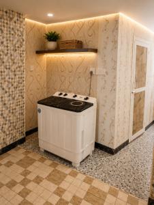a kitchen with a white stove in a room at Zanzibar stone town house in Zanzibar City
