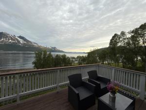 two chairs on a deck with a view of a lake at Trønderstua in Tromsø