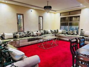 a living room with a couch and a red carpet at Villa Nono & Zac Marrakech in Ourika