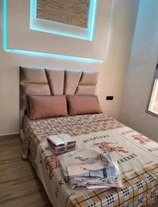 a bedroom with a bed with books on it at Villa Nono & Zac Marrakech in Ourika