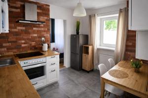 a kitchen with white cabinets and a black refrigerator at RosalieRose Cozy Corner in Radom