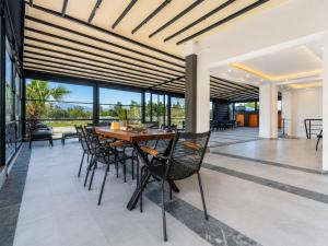 a dining room with a wooden table and chairs at The Orange Cactus in Antalya