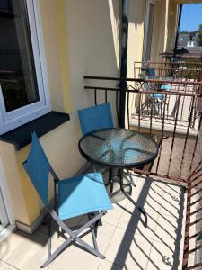 a table and two chairs on a balcony at SAViTA in Karwia