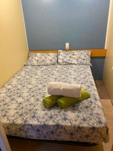 a small bed with two pillows on it at Little house paradise in Sant Pau dʼOrdal