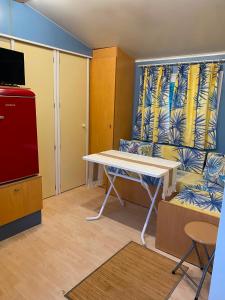 a living room with a table and a couch at Little house paradise in Sant Pau dʼOrdal