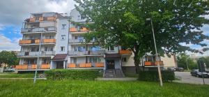a tall building with a tree in front of it at RosalieRose Cozy Corner in Radom