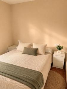 a bedroom with a large bed with two pillows at Casa con piscina y jacuzzi in Pontevedra +24 photos