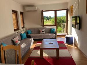 a living room with a couch and a table at Cozy 2 bedroom apartment in Sarajevo