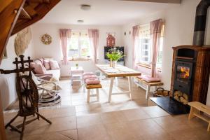 a living room with a table and a wood stove at Valašská chalupa Červenka in Lužná +29 photos