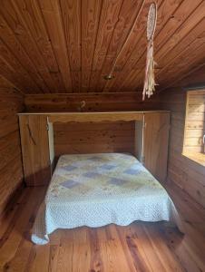 a bed in a cabin with a wooden ceiling at Gîte avec spa privatif et piscine de 2 à 10 voyageurs in Brassac +24 photos