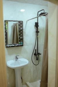 a bathroom with a sink and a shower with a mirror at Abelyans Fam Hotel in Alaverdi +12 photos