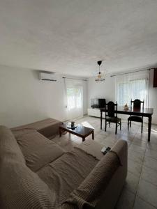 a living room with a couch and a table at Avli Cozy Home in Karditsomagoúla