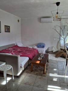 a bedroom with a bed and a coffee table at Avli Cozy Home in Karditsomagoúla