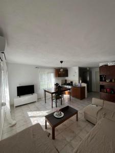a living room with a couch and a table at Avli Cozy Home in Karditsomagoúla