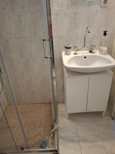 a bathroom with a sink and a shower at Avli Cozy Home in Karditsomagoúla +19 photos
