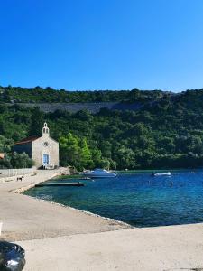 a church on the shore of a body of water at 150m to Beach - Free Parking - Garden View in Slano