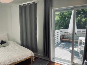 a bedroom with a bed and a sliding glass door at Victorian House B&B CozyWestmount in Westmount