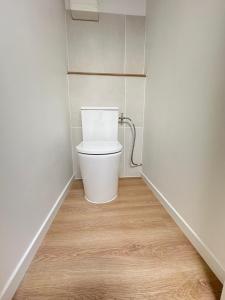 a bathroom with a toilet in the corner of a room at Aytré plage in Aytré