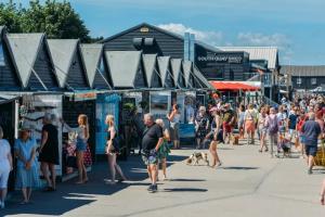 a large crowd of people walking around a market at Salt Yard 2 - Stylish Whitstable Cottage - Free Parking - Beach - Harbour in Whitstable