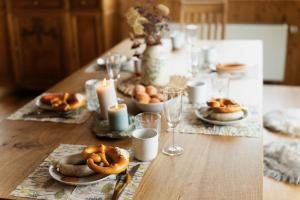 a table topped with plates of pretzels and candles at Alpe Sonnenruh in Buchenberg
