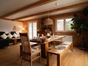 a living room with a table and chairs and a couch at Alpe Sonnenruh in Buchenberg