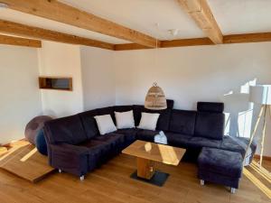 a living room with a couch and a table at Alpe Sonnenruh in Buchenberg