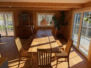 a dining room with a wooden table and chairs at Alpe Sonnenruh in Buchenberg