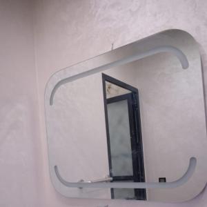 a mirror hanging on a wall in a bathroom at Villa world Marrakech in Marrakesh