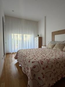 a bedroom with a bed and a dresser and a window at Son do Mar in Porto do Son +19 photos