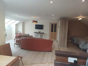 a living room with a couch and a bed at Ethan House Holiday Suites in Killarney