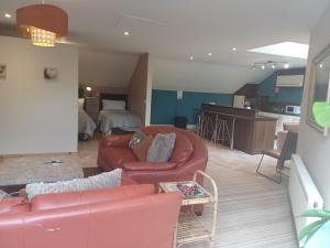 a living room and kitchen with a couch and a table at Ethan House Holiday Suites in Killarney