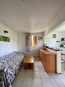a bedroom with a bed and a desk in it at Corossole in Bouillante