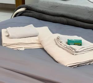 a bed with two beds with towels on it at Lady Estúdio - Hotel + café em Extrema MG in Extrema