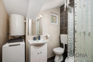 a bathroom with a toilet and a sink and a shower at Rona Apartments Zlatko in Šimuni +50 photos