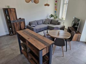 a living room with a couch and a table at Echternach Center Charming Apartment in Echternach