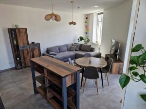 a living room with a couch and a table at Echternach Center Charming Apartment in Echternach +15 photos