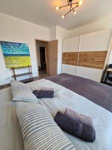 a bedroom with a large bed with pillows on it at Echternach Center Charming Apartment in Echternach