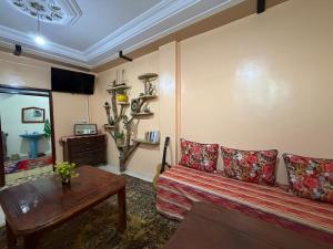 a living room with a couch and a table at Gaia guest house in Taghazout