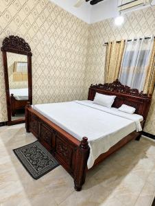 a bedroom with a large bed and a mirror at Zanzibar stone town house in Zanzibar City