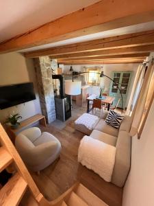 a living room with a couch and a table at Lill' Hill estate & wellness - Lumina Chalet in Idrija