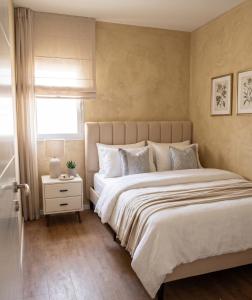 a bedroom with a large bed and a window at North Station Residence Beer Sheva in Beer Sheva