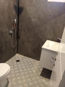 a bathroom with a shower and a toilet and a sink at North Station Residence Beer Sheva in Beer Sheva