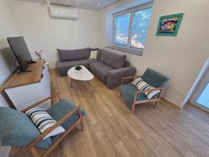 a living room with a couch and a table at The Kiwi House in Ohrid +24 photos