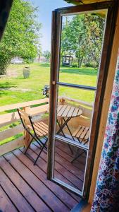 an open door to a porch with a picnic table at Zaścianek Roztocze in Chłopków