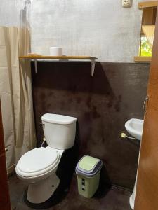 a bathroom with a toilet and a sink at Majacho`s House in Puerto Maldonado