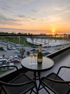 a table with two glasses of wine on a balcony at Mar y Sol in Batumi