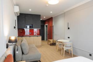 a living room with a couch and a kitchen at Апарт-готель Select in Lviv