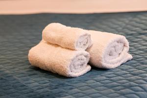 a pair of towels sitting on top of a bed at La Dimora di Alba in Palermo +242 photos